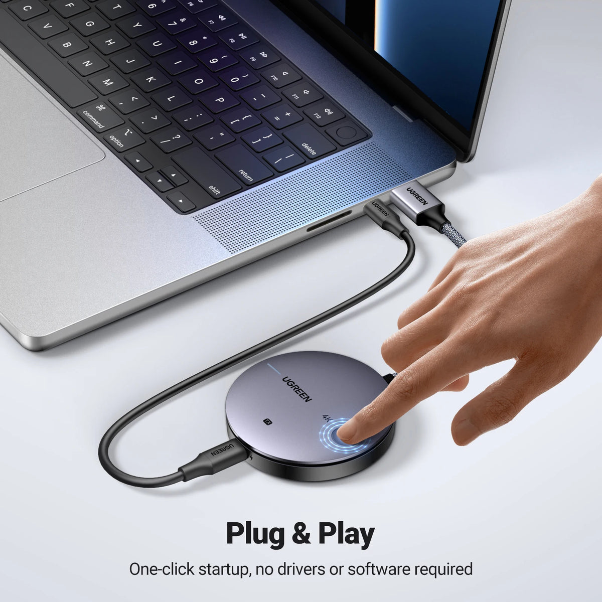Laptop with a round USB hub and a hand pressing a button, on a white background.