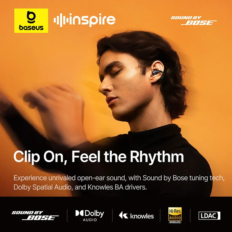 Person wearing earbuds with Baseus and inspire branding on an orange background