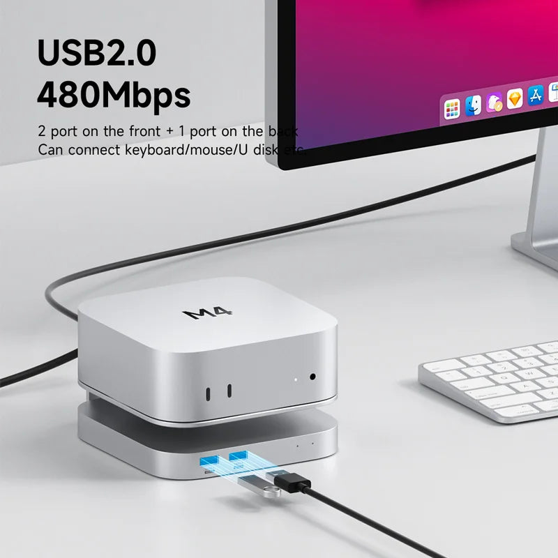 USB hub with multiple ports connected to a computer monitor and keyboard on a desk.