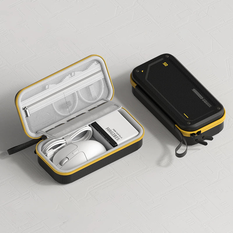Black and yellow carrying case with a mouse, cable, and power bank on a light gray background