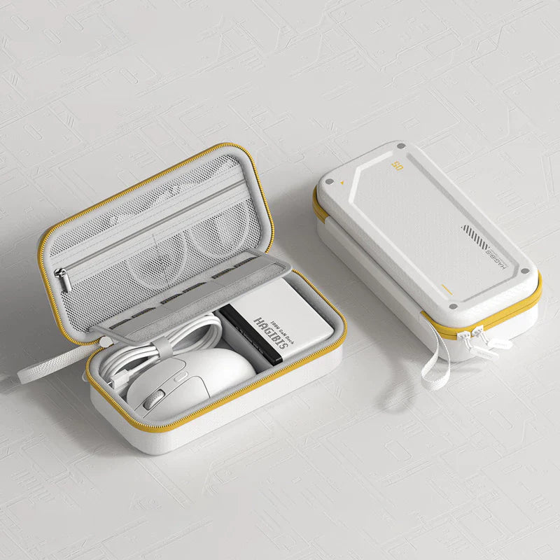 White electronic case with yellow accents containing a mouse, power bank, and other items on a light gray background.