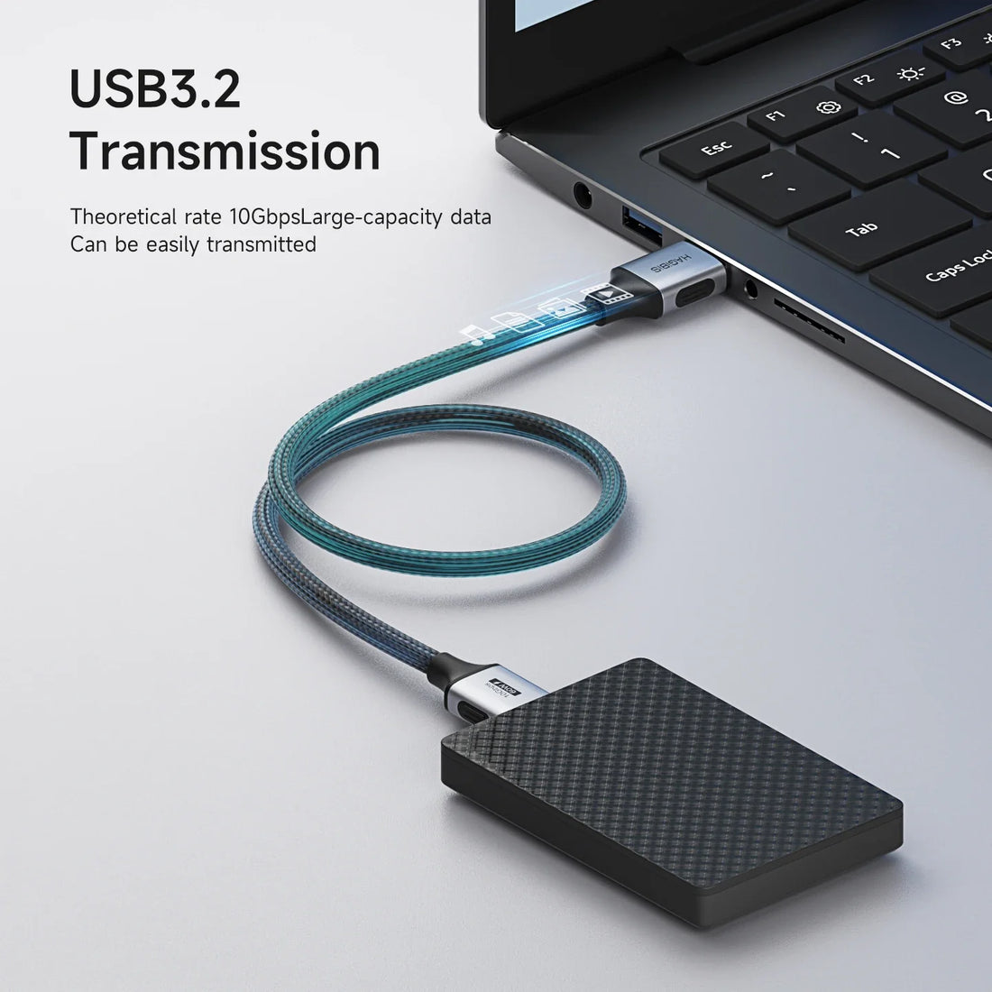 USB 3.2 transmission cable connected to a laptop on a light gray background