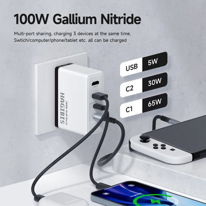 100W gallium nitride charger with multiple devices being charged on a gray surface.