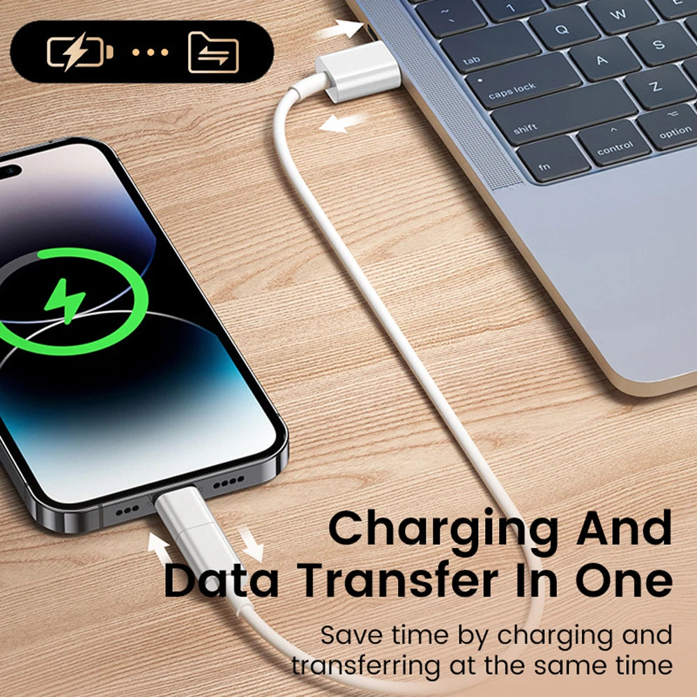 Phone charging and data transferring with a cable connected to a laptop on a wooden surface.