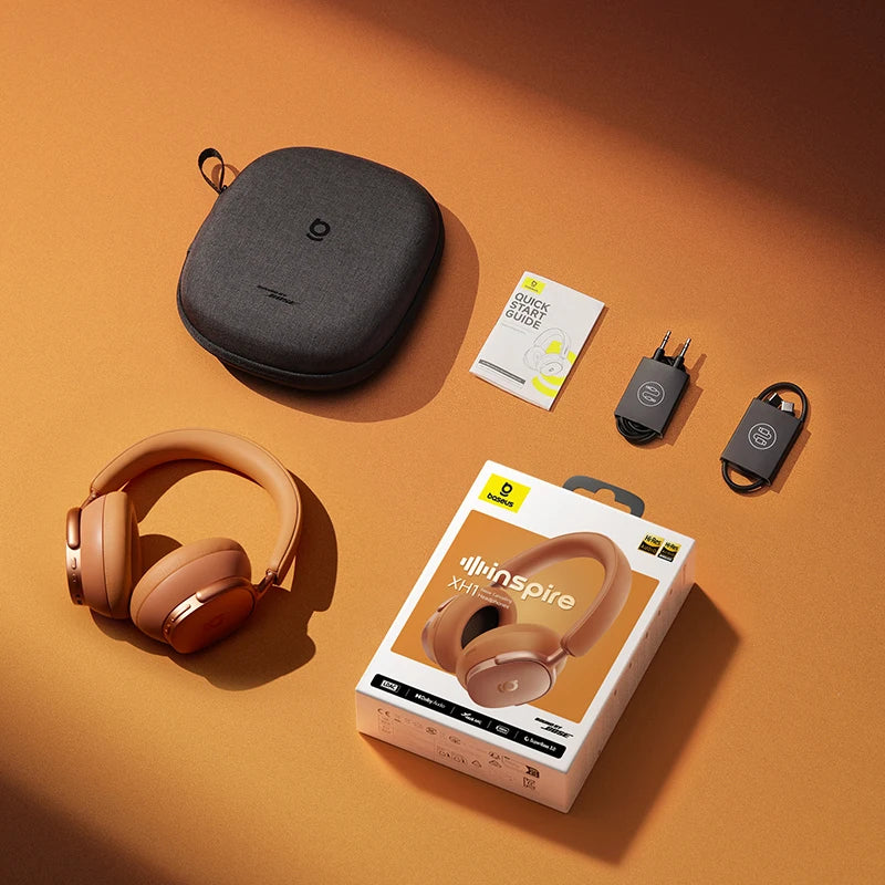 Bose headphones with packaging, carrying case, and accessories on an orange background