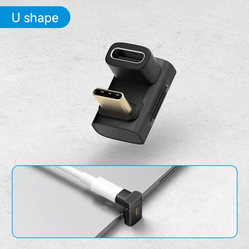 Black U-shaped cable management tool with USB-C connector on a light gray background