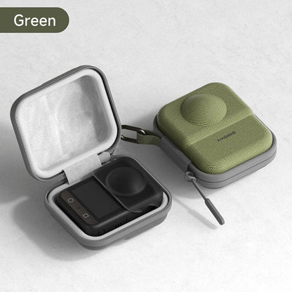 Green travel case with a black device inside on a light gray background