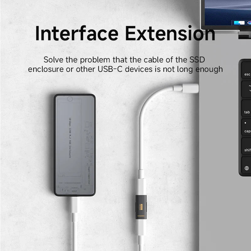 USB-C extension cable with SSD enclosure and laptop on a light gray background