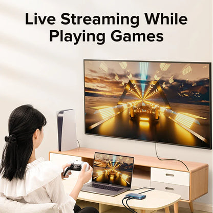 Person live streaming while playing games on a laptop and TV.