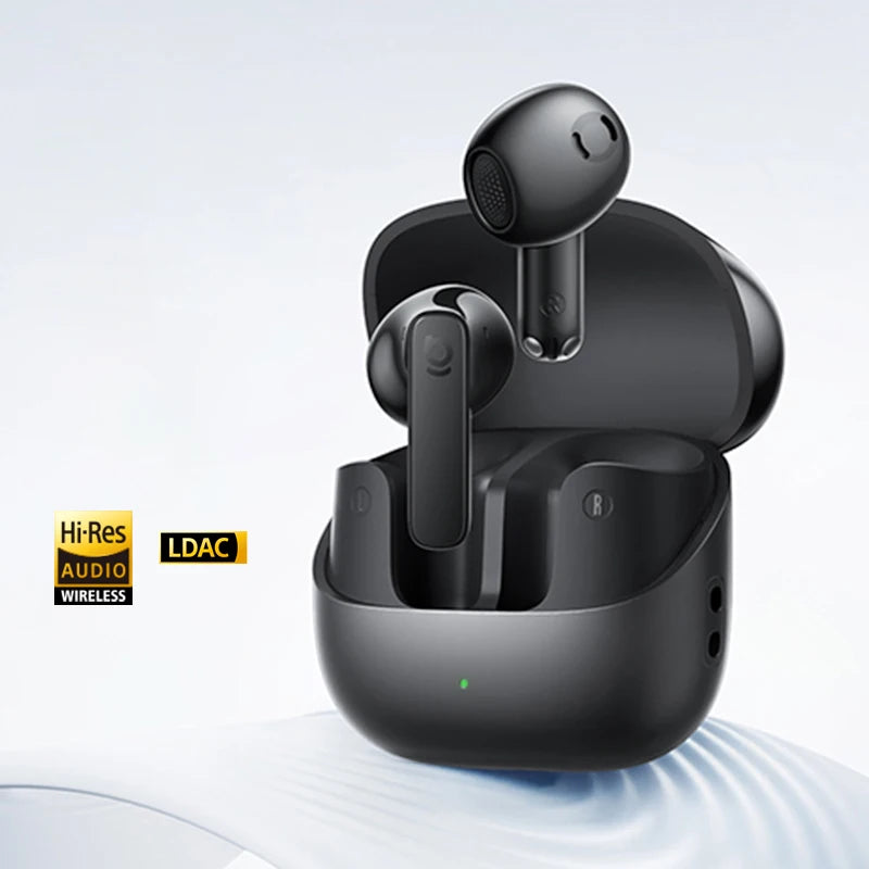 Black wireless earbuds with charging case on a light gray background