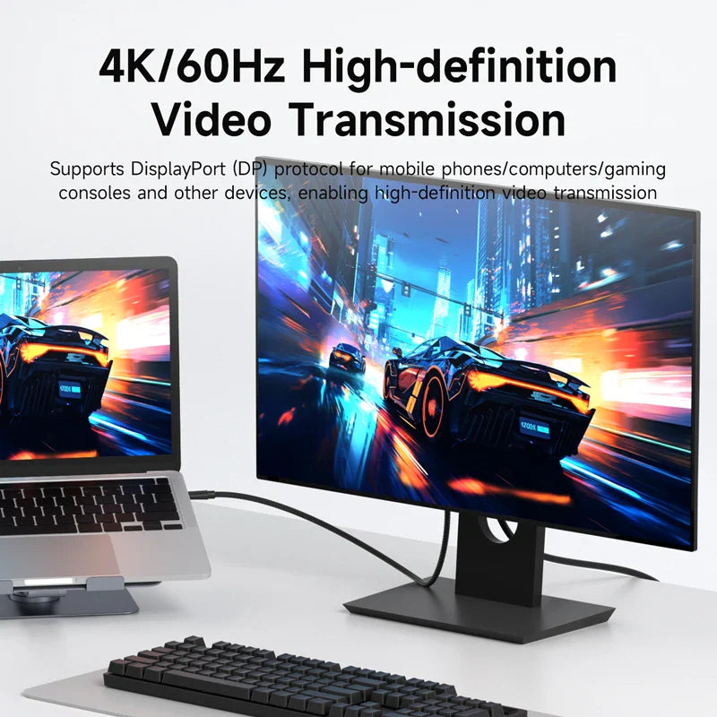 Gaming setup with monitor, laptop, and keyboard displaying high-definition video transmission.