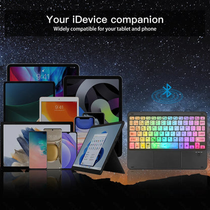 Colorful keyboard with Bluetooth symbol on a dark background with multiple electronic devices.