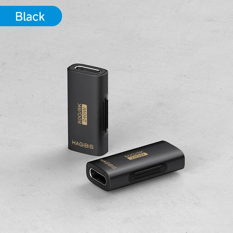 Two black electronic devices with gold text on a gray surface