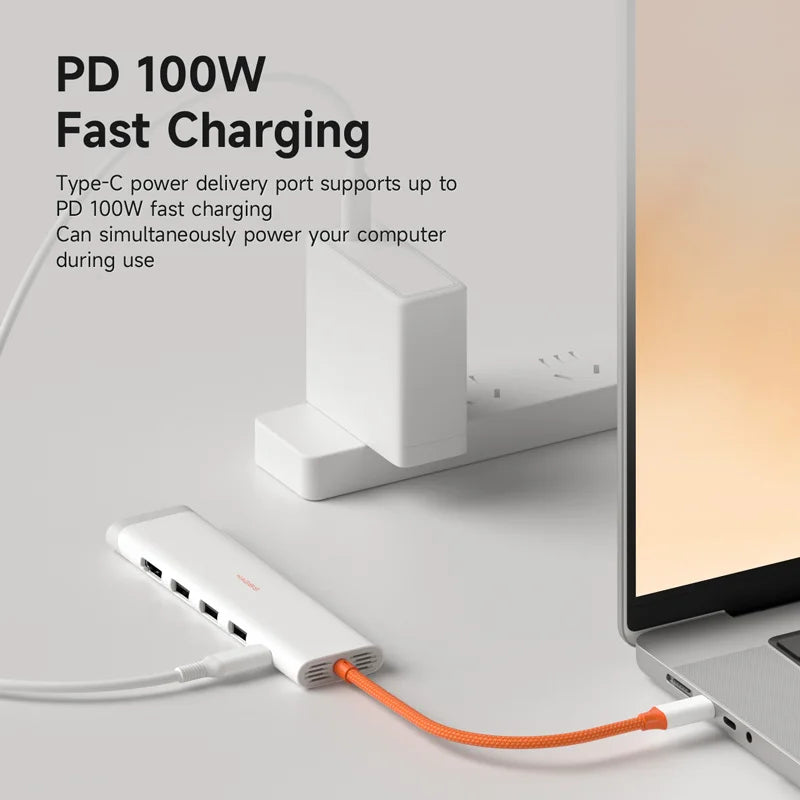 PD 100W fast charging adapter with laptop on a light gray background