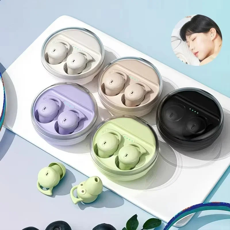 Colorful wireless earbuds in their cases on a light blue background