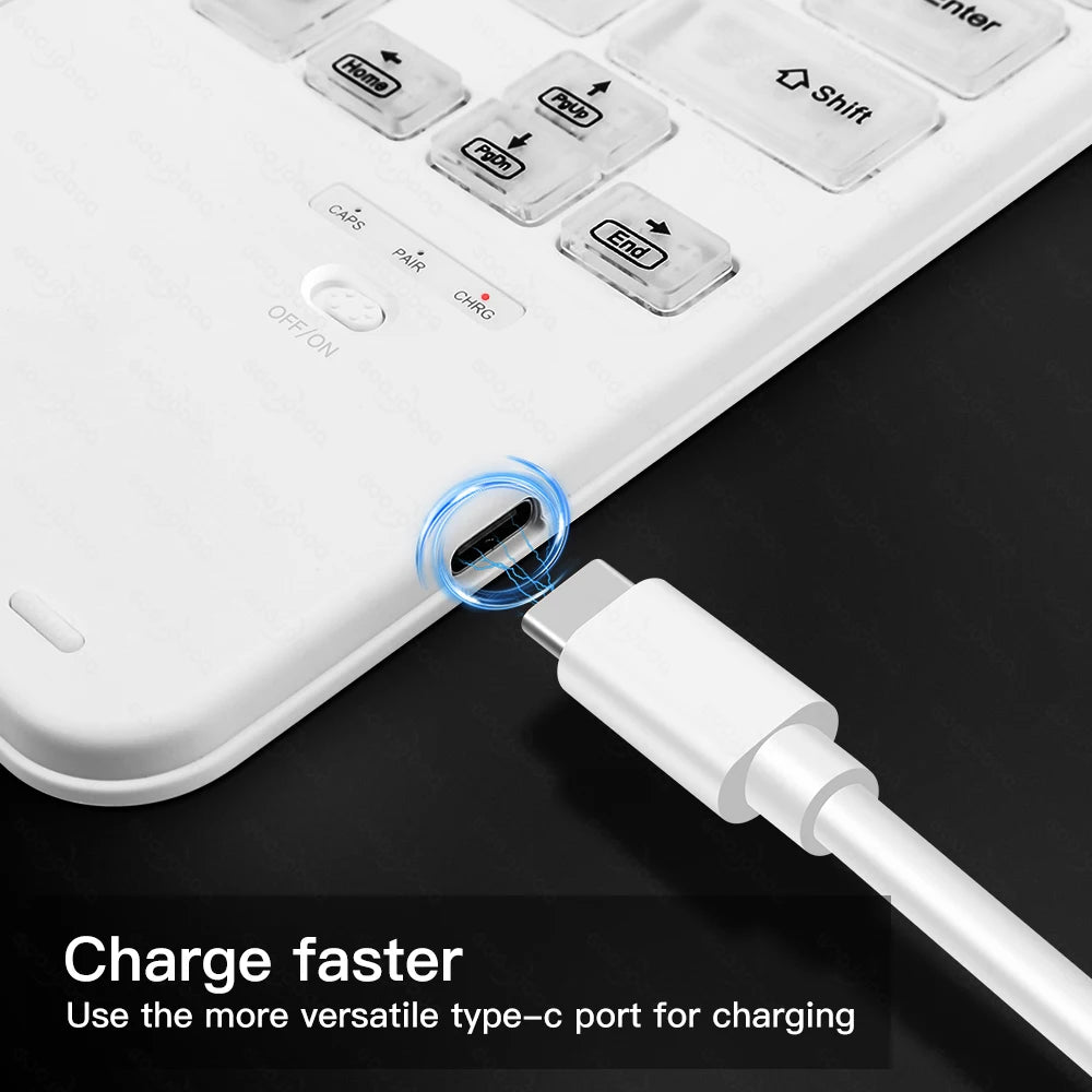 White USB-C cable being plugged into a white keyboard on a black surface.