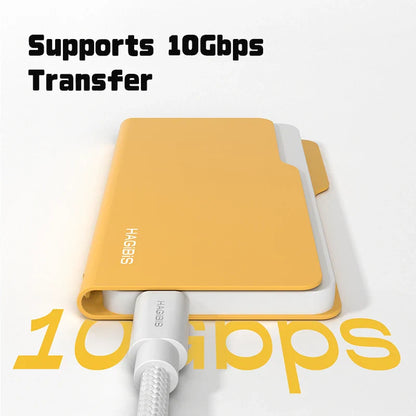 Yellow external hard drive with cable on a white background, featuring the brand 'HAGGIS'.