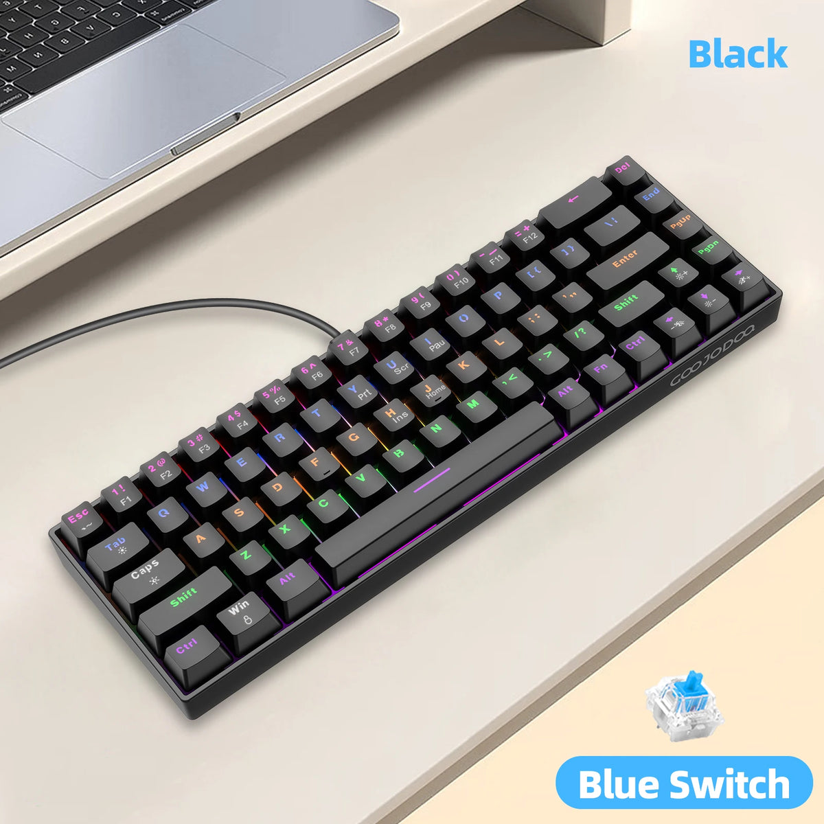 Mechanical keyboard with blue switches on a desk next to a laptop