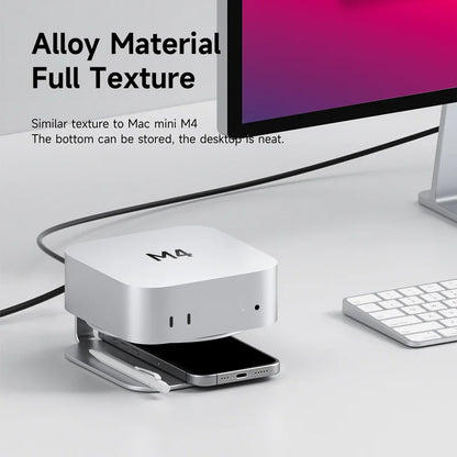 Metallic device with 'M4' branding on a desk setup with a computer and keyboard.