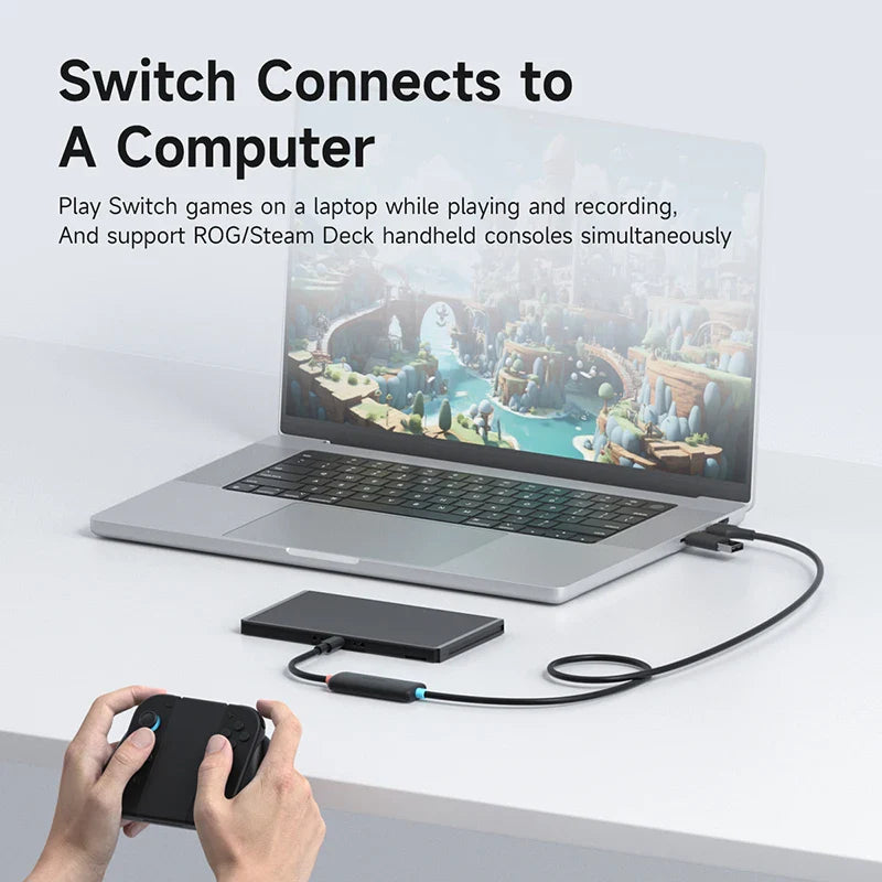 Laptop connected to a handheld device with text about gaming compatibility.