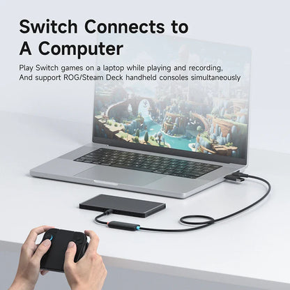 Laptop connected to a handheld device with text about gaming compatibility.