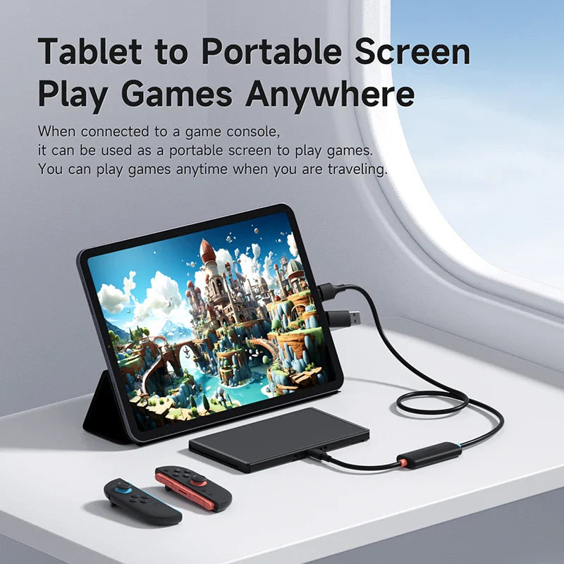 Tablet connected to a portable screen adapter with game console remotes on a surface.