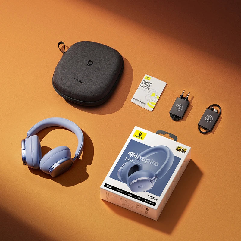 Blue headphones with packaging, carrying case, and accessories on an orange background