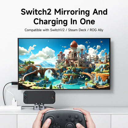 Gaming setup with TV displaying a fantasy game, controller, and device for Switch2 mirroring and charging.