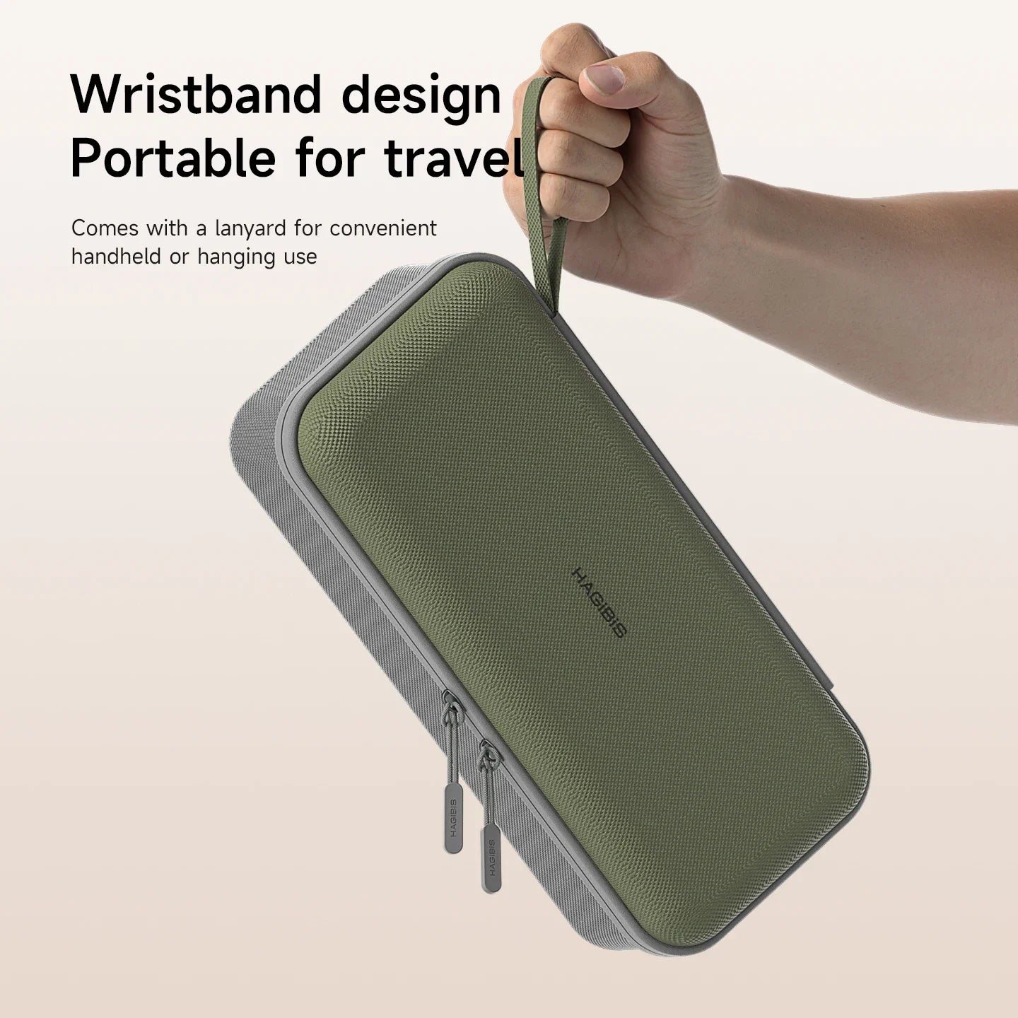 Green travel case with wrist strap held by a hand on a beige background