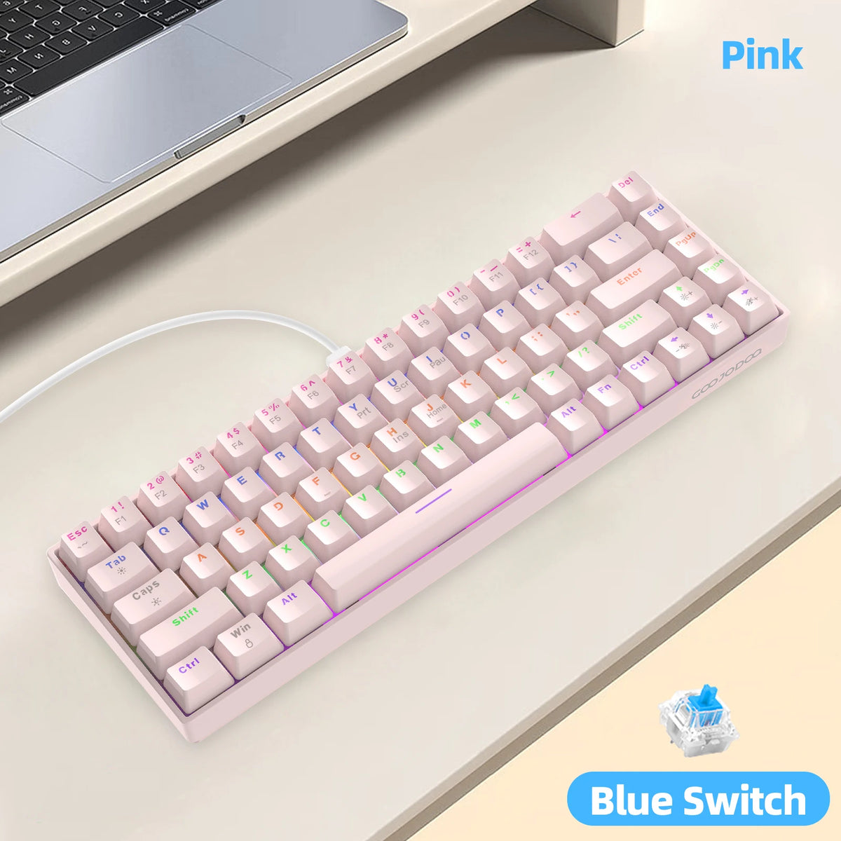 Pink keyboard with blue switches on a desk next to a laptop