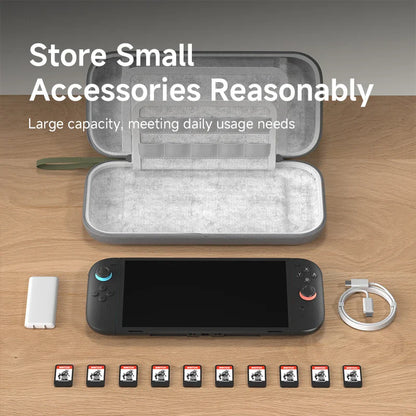 Open gray case with small accessories on a wooden surface, including a handheld device and multiple small items.