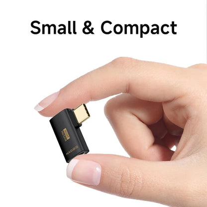 Small and compact adapter held between fingers with 'Small & Compact' text above.