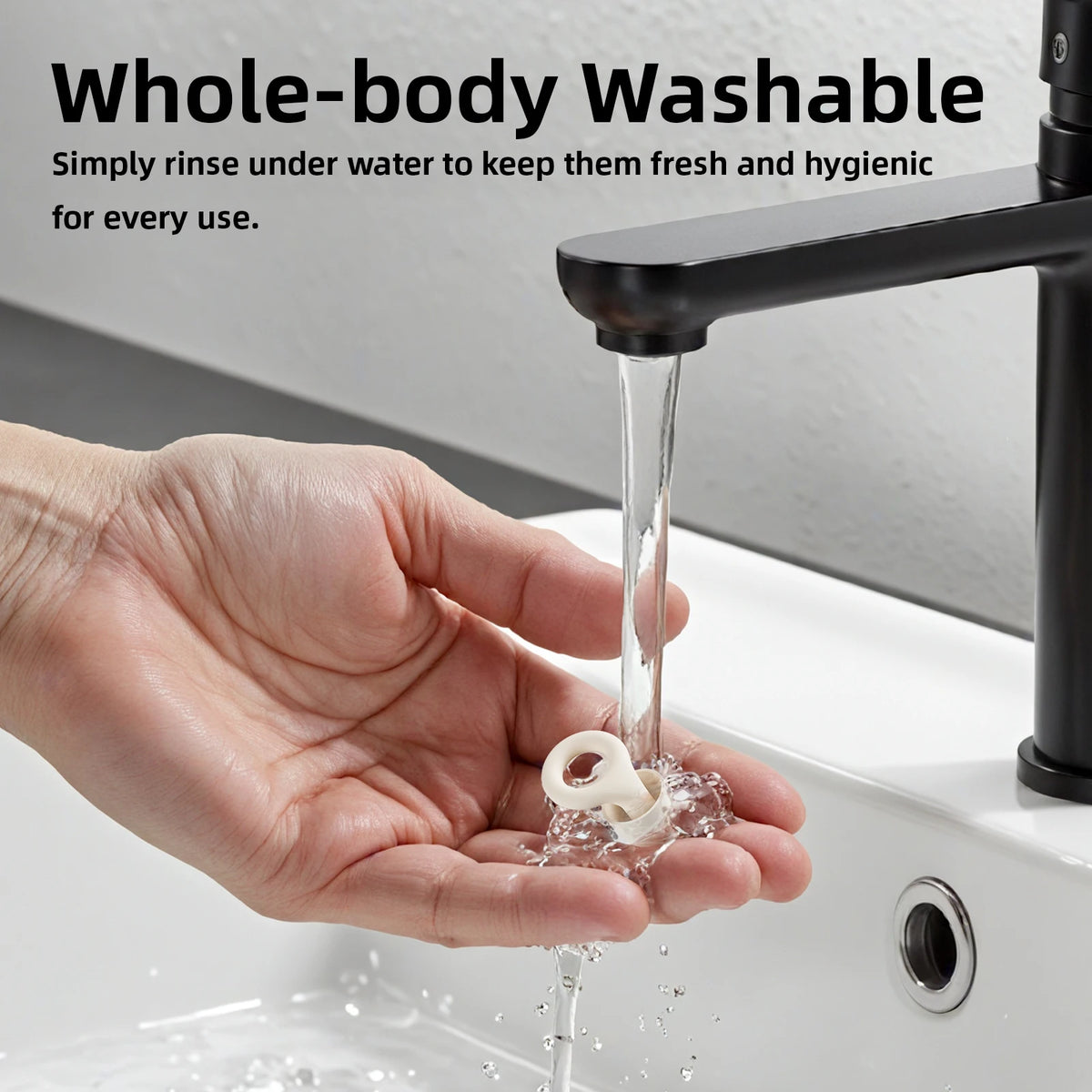 Hand washing a white object under running water from a black faucet with text about whole-body washability.