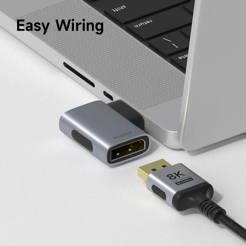 Laptop with USB-C adapter and 8K cable on a white surface, labeled 'Easy Wiring'.