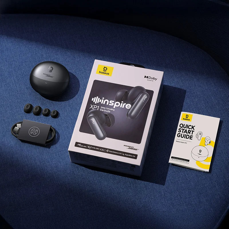 Bose Inspire XP1 earbuds with packaging and quick start guide on a blue surface