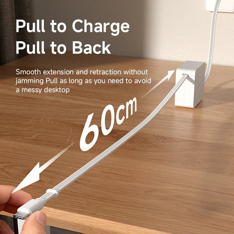 Extension cable with pull-to-charge and pull-to-back feature on a wooden desk.