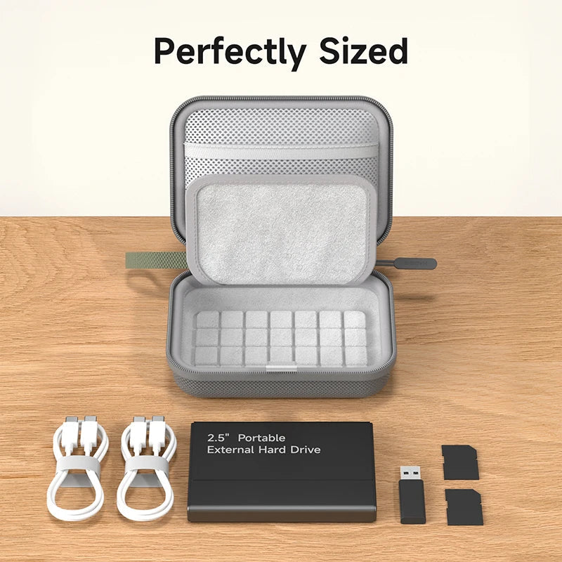 Gray portable external hard drive case with accessories on a wooden surface