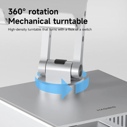 Mechanical turntable with 360-degree rotation feature on a gray surface.