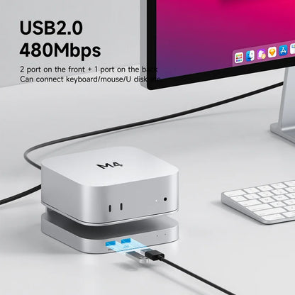 USB hub with multiple ports connected to a computer monitor and keyboard on a desk.