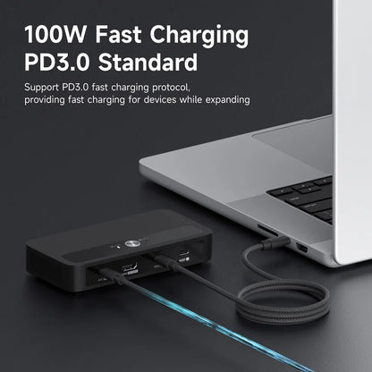 Laptop with a charging device connected, featuring text about 100W fast charging and PD3.0 standard.